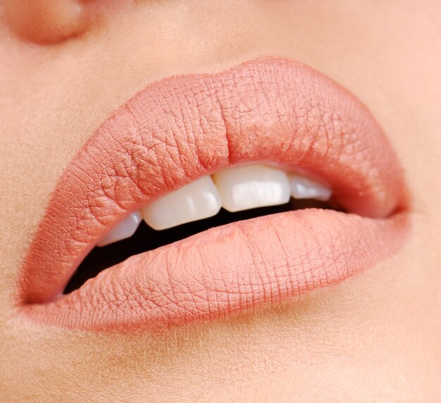 Woman lips with natural color of lipstick