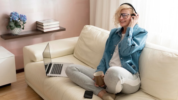 Woman listening to music and holding coffee mug