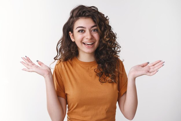 woman living relaxed life shrugging hands raised sideways clueless smiling laughing uninterested people problems