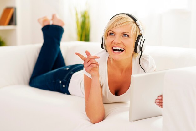 Woman in living room listening music