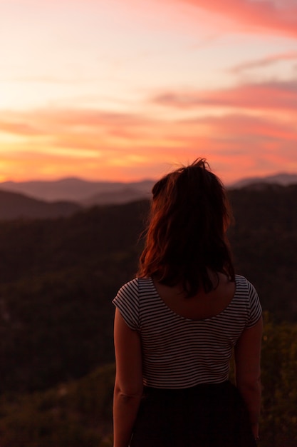 Woman looking away from behind shot