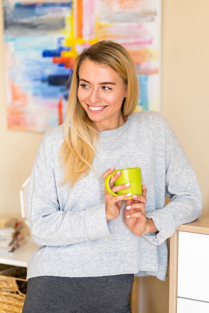 Woman looking away and holding a cup of coffee