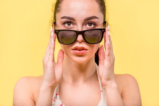 Woman looking over big sunglasses