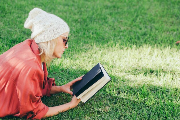 woman looking at book cover