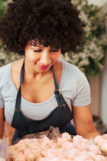 Woman looking at bunch of white flowers