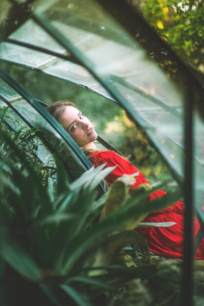 Woman looking at camera and blurred foliage