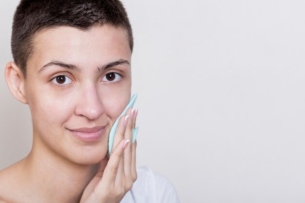 Woman looking at camera cleaning face