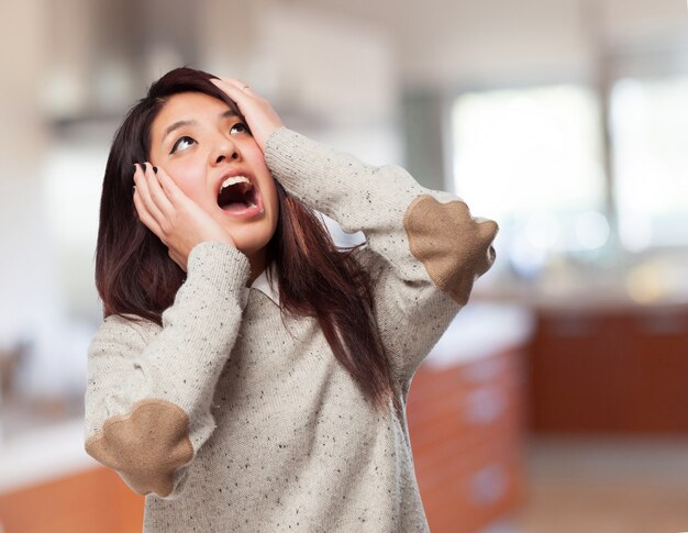 Woman looking at the ceiling and screaming