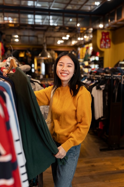 Free photo woman looking at clothes medium shot