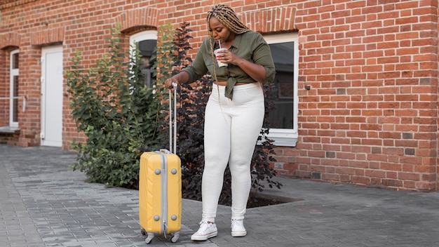woman looking down to her luggage