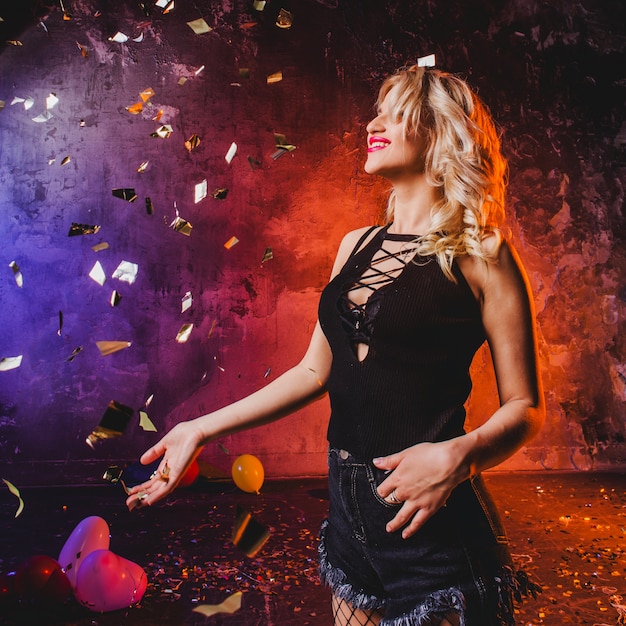 Woman looking at falling confetti