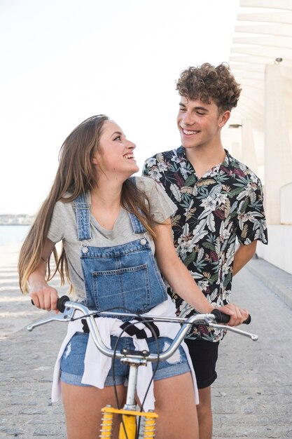 Woman looking at her boyfriend while riding bicycle