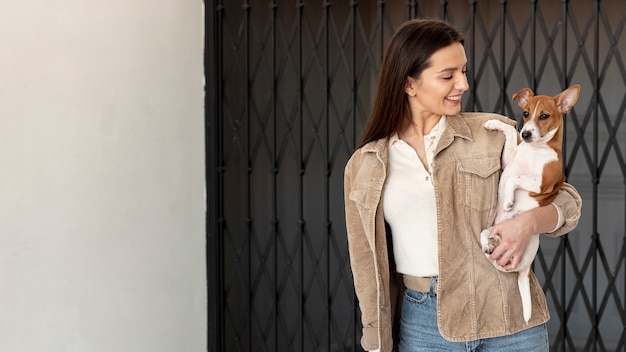 Woman looking at her dog while posing