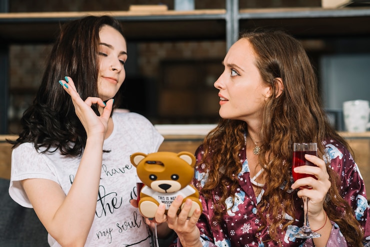 Free Photo woman looking at her friend showing ok sign