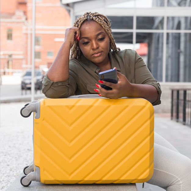 Woman looking at her phone while waiting for a call