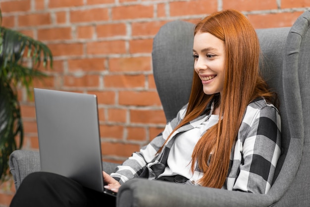 Woman looking at laptop side view