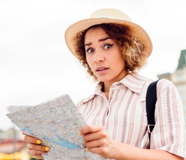 Woman looking like she's lost after checking her map