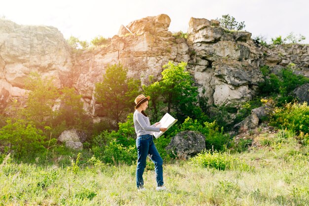 Woman looking at map in nature