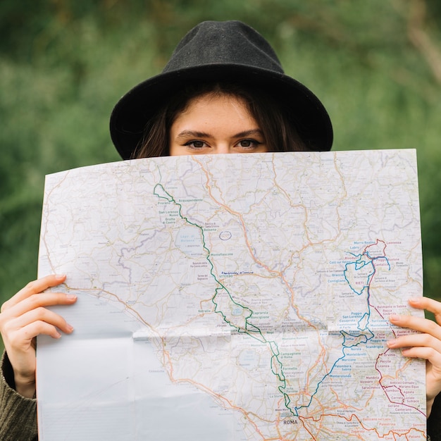 Woman looking at a map in nature – Free Stock Photos