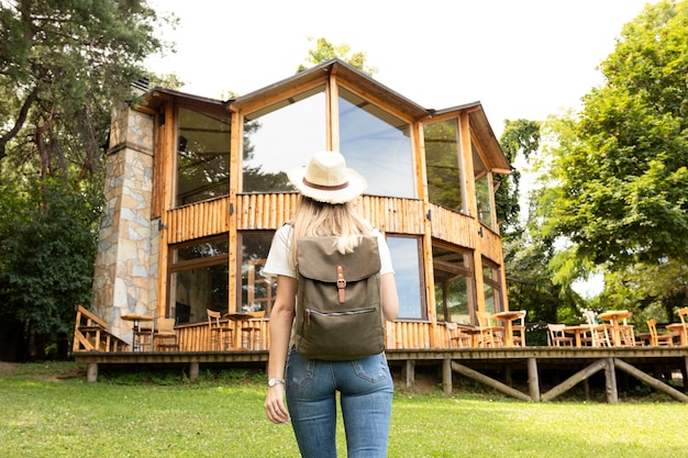 Woman looking at modern house from behind