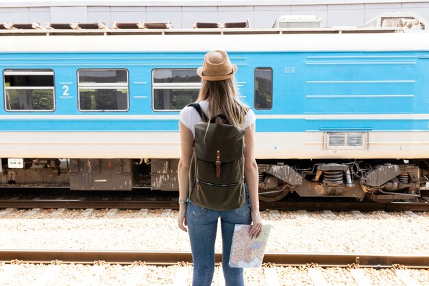 Woman looking at a passing train from behind