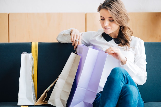 Free photo woman looking at purchases