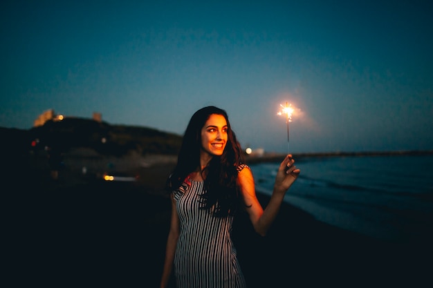 Free photo woman looking at sparkler