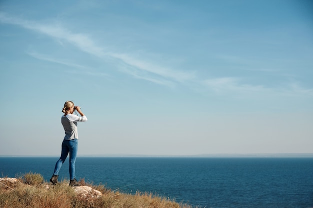 Woman looking through binoculars