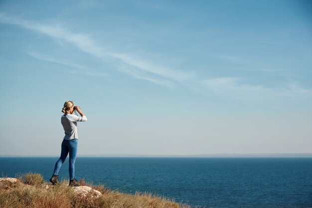 Woman looking through binoculars