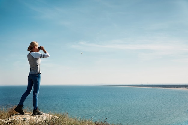 Woman looking through binoculars