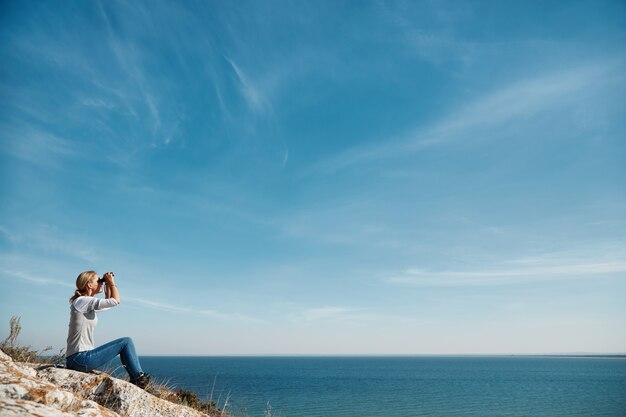 Woman looking through binoculars