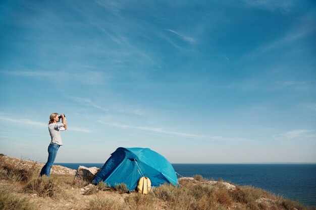 Woman looking through binoculars