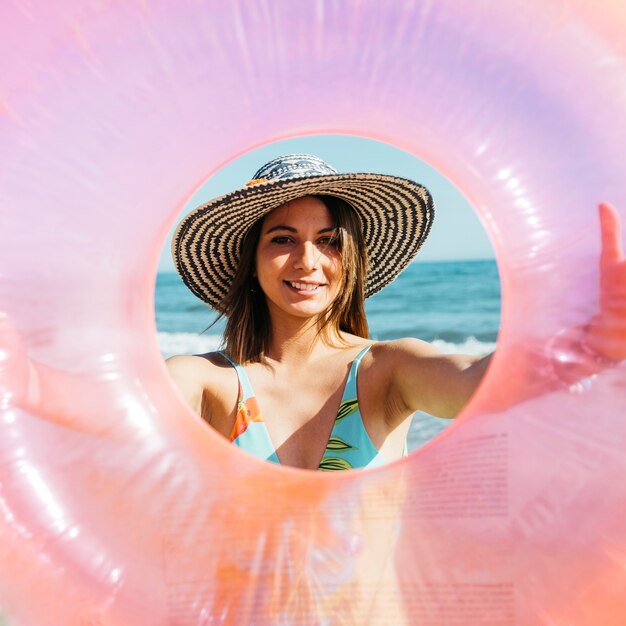 Woman looking through inflatable ring