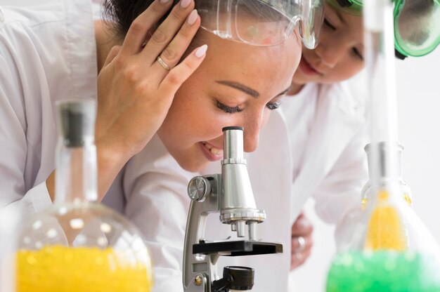 Woman looking through microscope