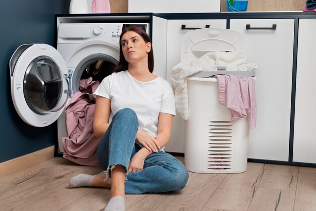 woman looking tired after doing the laundry