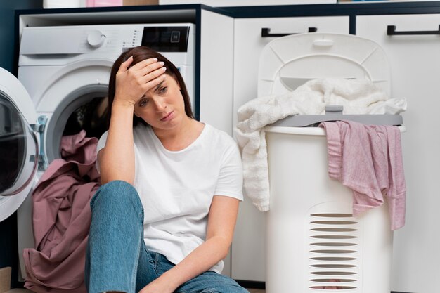woman looking tired after doing the laundry