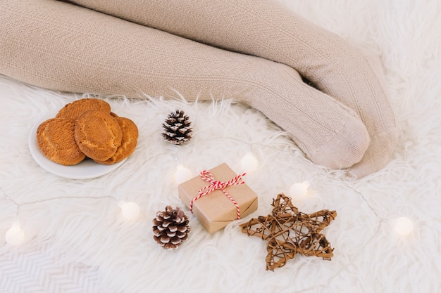 Woman lying on bed with gift box 