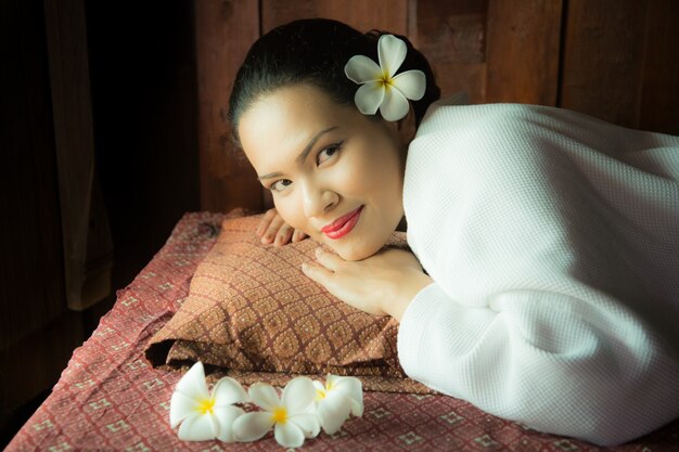 Woman lying down embracing a pillow