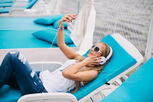 Woman lying and enjoying music