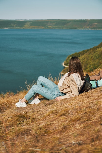 Free photo woman lying on green hill during hiking at bakota area