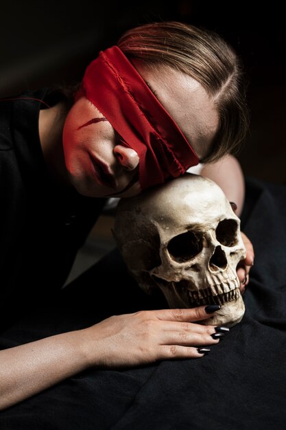 Woman lying her head on skull