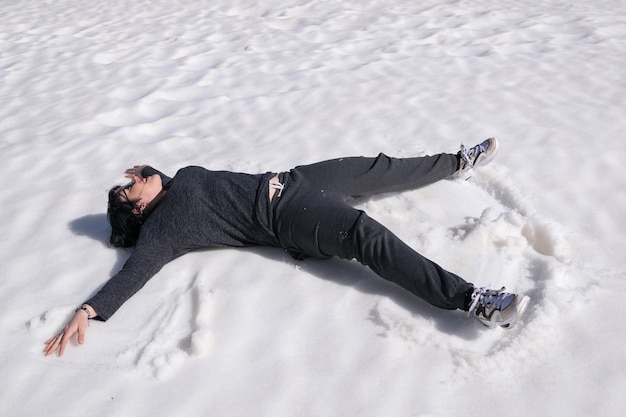 Free photo woman lying in the snow
