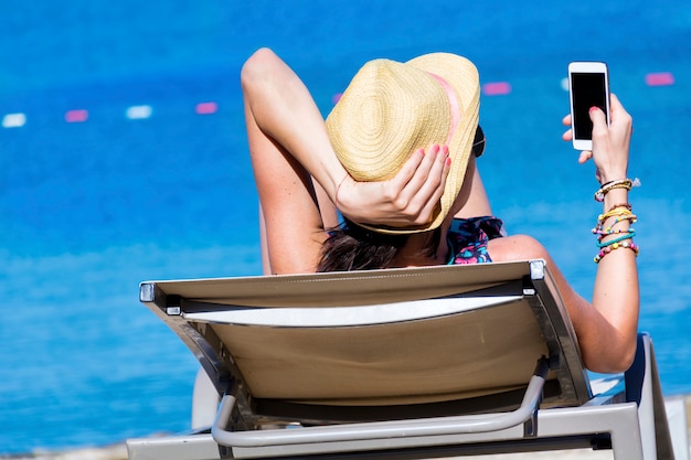 Woman lying staring at her mobile