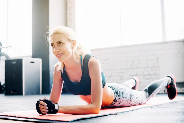 Woman lying on stretch mat