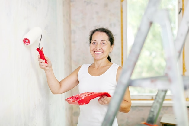 woman makes repairs at home
