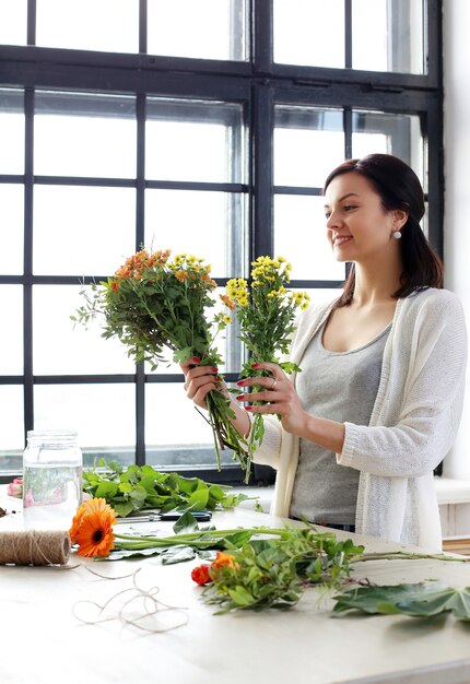 Woman making a beautiful floral bouquet