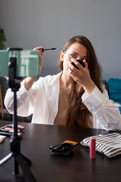 Woman making a beauty vlog with her smartphone