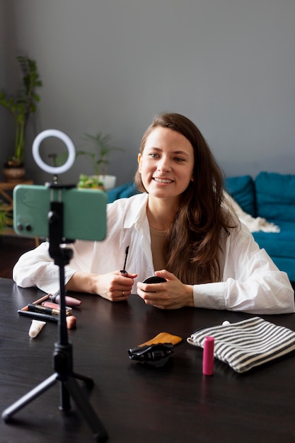 Woman making a beauty vlog with her smartphone