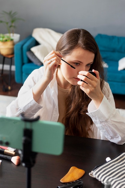 Woman making a beauty vlog with her smartphone