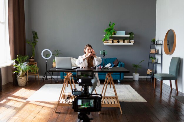 Woman making a beauty vlog with her smartphone